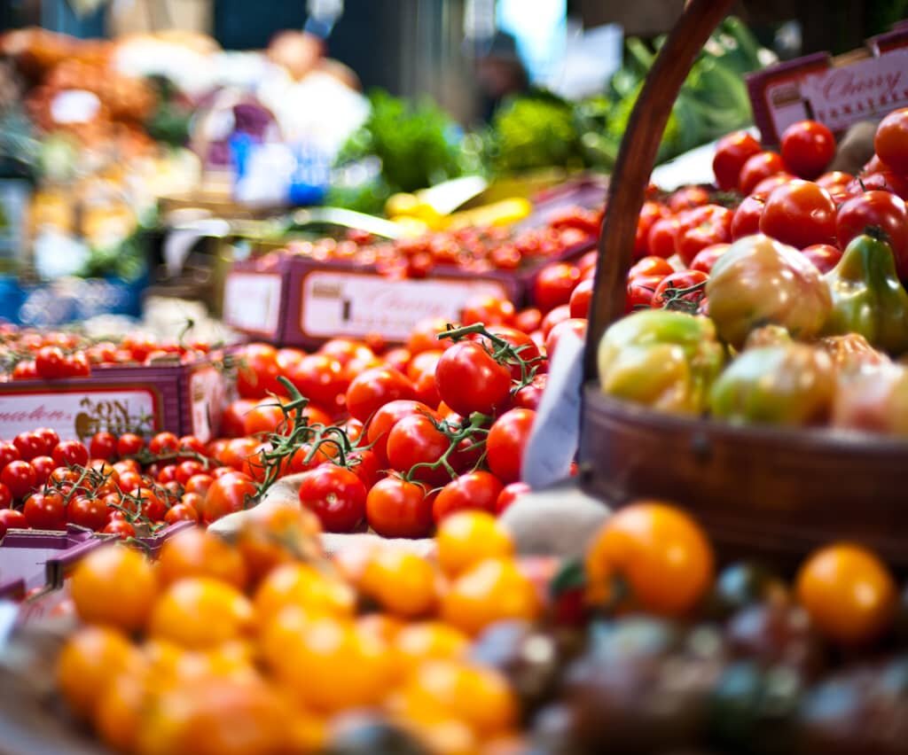 Assorted tomatoes and fruits showcased in vibrant display.