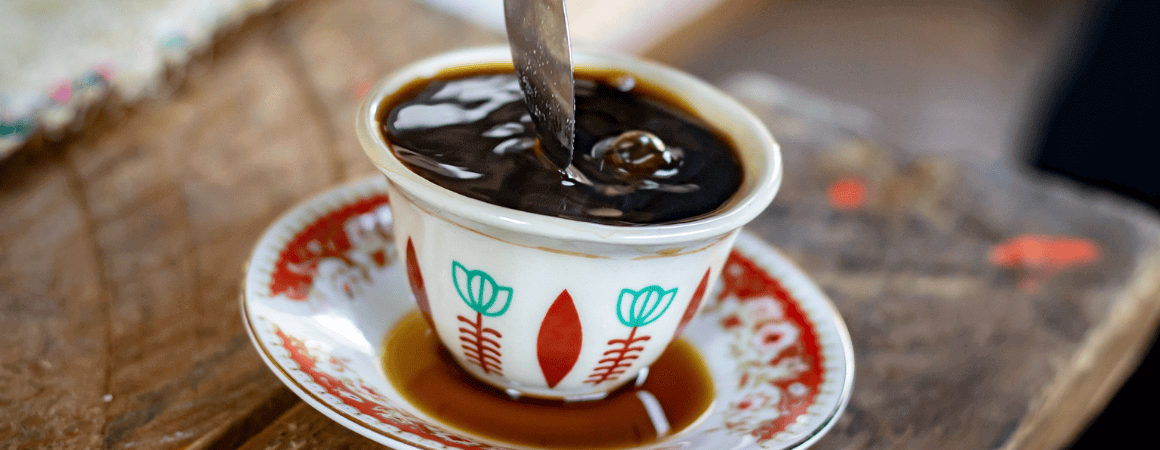 A steaming cup of coffee on a saucer, ready to be enjoyed. siginfying Ethiopian Traditional Coffee Ceremony Steps -by-Step