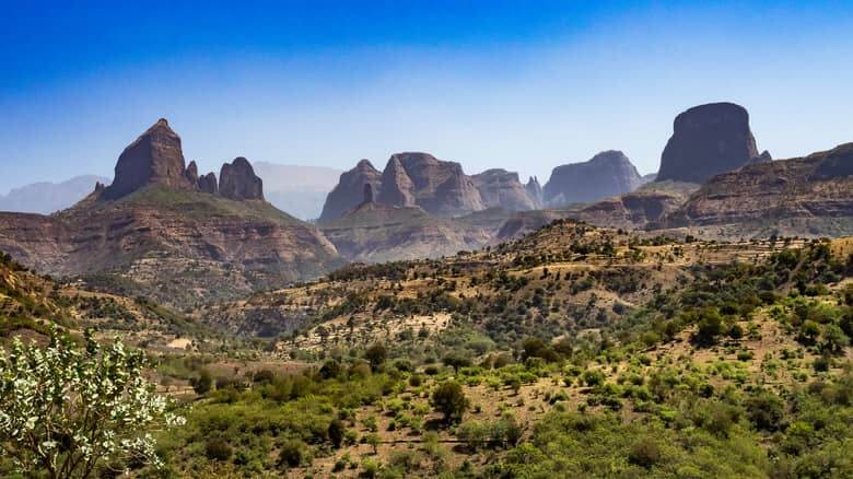 Greenery drapes the peaks of Ethiopia within Simien Mountains National Park.