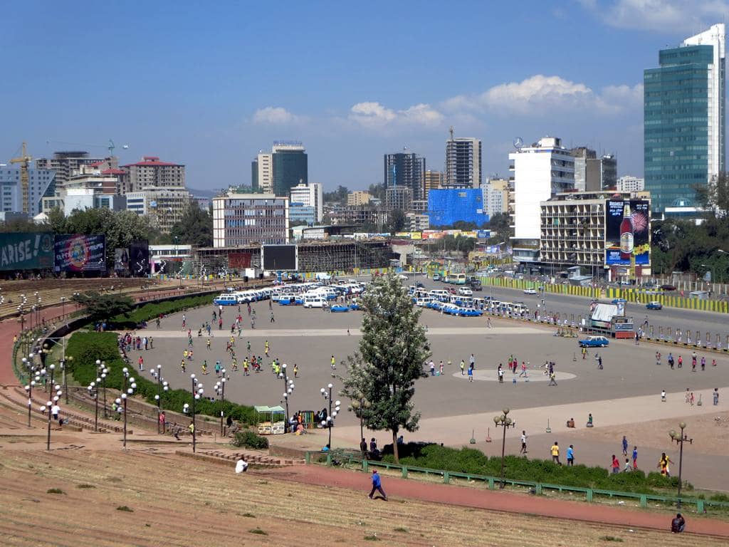 Meskel Square in Addis Ababa, featuring a vibrant cityscape, expansive park, and bustling crowds.