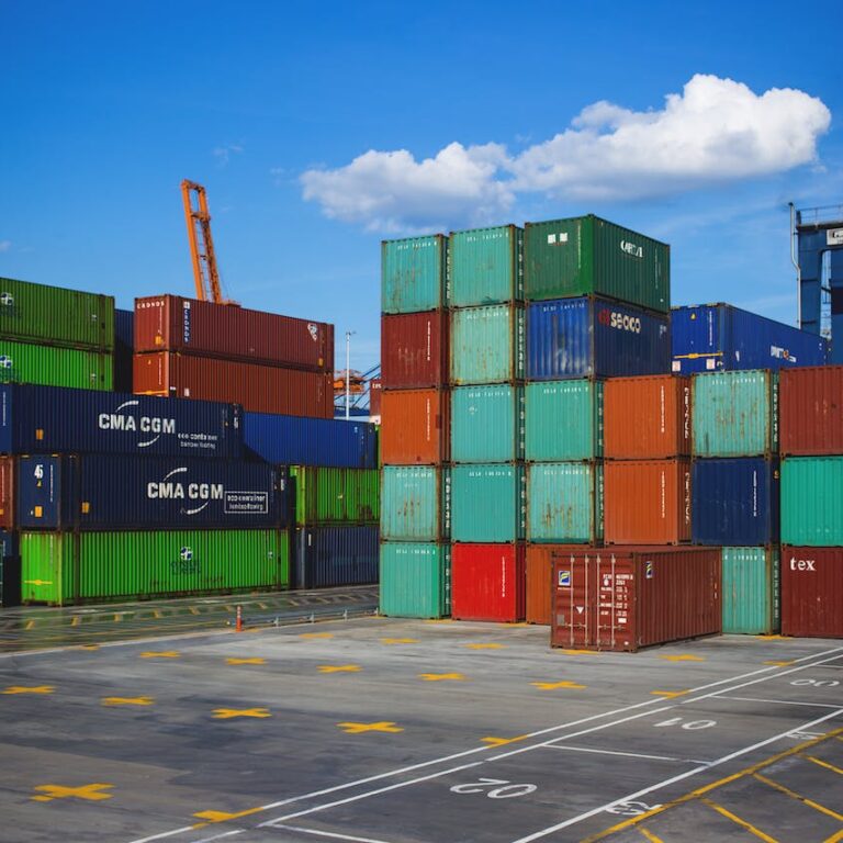 A busy container yard filled with stacked containers, showcasing a bustling hub of international trade.